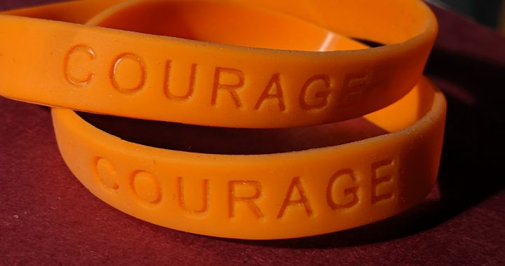 Orange "Courage" silicone message bands. Photo by Jennifer Willis, 2019.